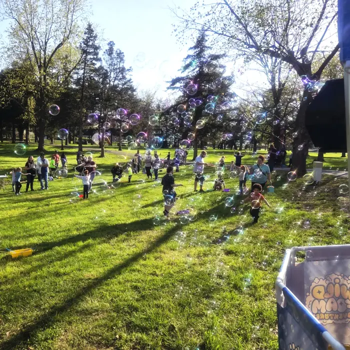 Kids chasing giant bubbles at a bubble party
