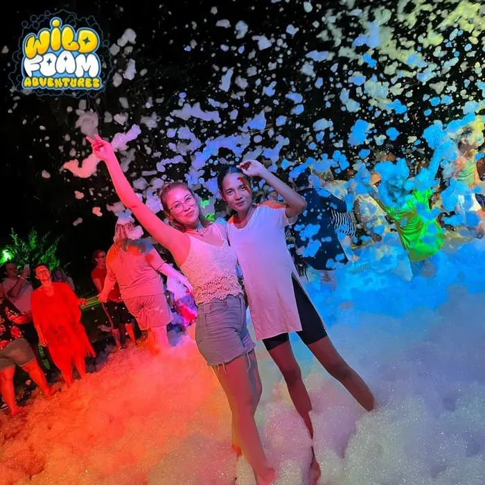 A night foam party lit with party lights