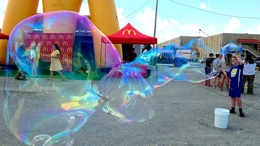 A bubble machine filling a park with bubbles
